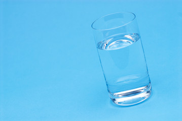 Glass of water isolated on blue background