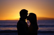 © Phase4Photography - Silhouette of a young couple kissing on the beach at sunset