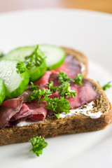 Wall Mural - Delicious healthy sandwich on brown with roastbeef and cucumber