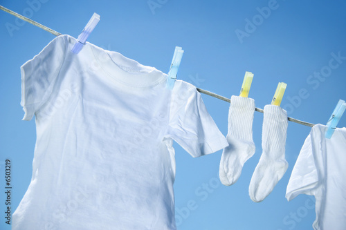 Fotografie, Obraz Eco friendly laundry drying on clothes line against a blue sky