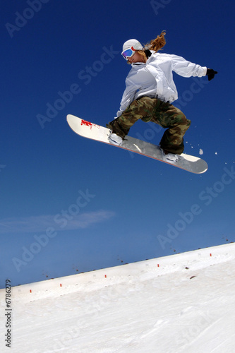 Fotografie, Obraz woman snowboarder in flight with sky behind