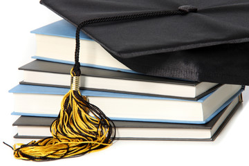 graduation cap and books on white background