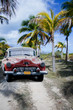 Old car on a tropical beach