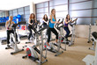 © .shock - Women working out on spinning bikes at the gym
