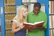 © Monkey Business - Two university students working in library