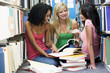 © Monkey Business - Three students working together in library