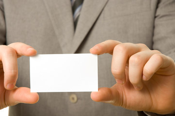 Blank business card in the hands of a businessman