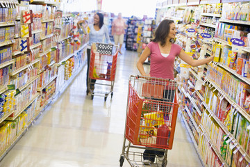 Two women shopping in supermarket