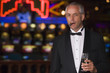 © Monkey Business - Man wearing tuxedo in casino