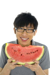  young Asian boy eating fruit