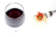 Glass of red wine and fork with spaghetti