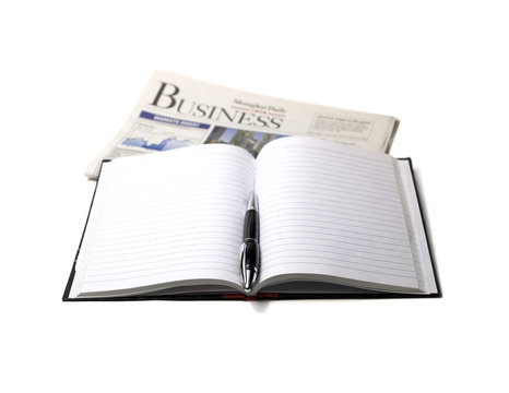 newspaper ,pen and notebook