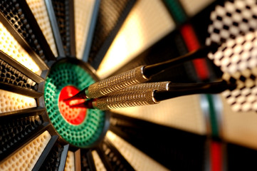 three arrows in the centre of a dart board