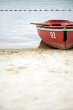 Red Rowing Boat With Number 92 At Beach
