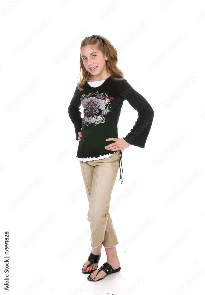 young girl standing with hands on hips and legs crossed. Stock Photo ...