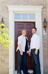 Couple in Front of Their Home