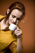 redhead woman with hot coffee cup