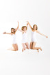 © Doreen Salcher - three beautiful smiling women are jumping on white background