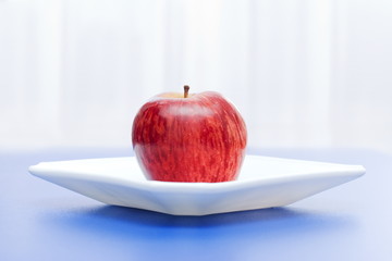 Apple in white plate