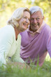 © Monkey Business - Couple relaxing in park smiling