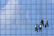 Window Washers On Glass Building Facade