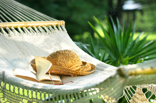 Valokuva Hammock, book, hat, and glasses on a sunny day