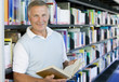 © Monkey Business - Senior man reading in a library