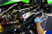 Mechanic Working On Racing Car Engine