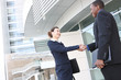 © Stephen Coburn - Diverse Business Man and Woman Handshake