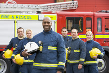 Portrait Of A Group Of Firefighters By A Fire Engine