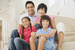 © Monkey Business - Family sitting on staircase smiling