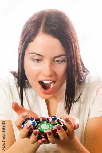 Fotografie, Obraz Girls holding a bunch of poker chips (focus on face)