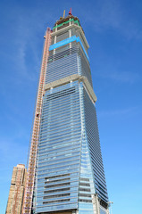 Highrise building in construction over blue sky