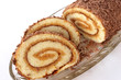 Swiss roll with two cut off slices on a glass dish