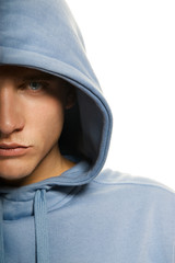 Wall Mural - Handsome young man in a hood isolated on white background