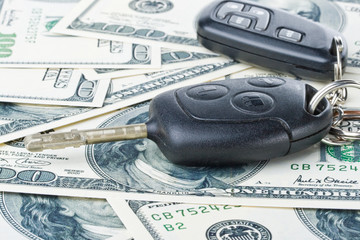 Car keys and money on a white background