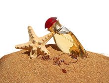 Perfume And A Necklace Isolated On A Sand Background