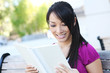© Stephen Coburn - A cute young asian woman reading on college campus