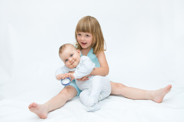 Poster - little brother and sister playing together, on white