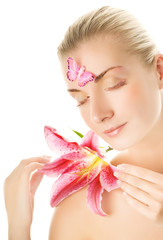 Beautiful young woman with pink lily close-up portrai