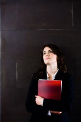 Sticker - Young businesswoman in dark suit holding red folder