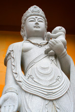 Buddhist Temple Statue Of A Woman Holding A Baby