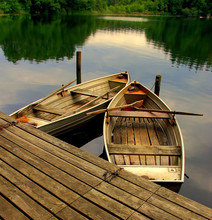 Two Old Rowing Boats On A Lake