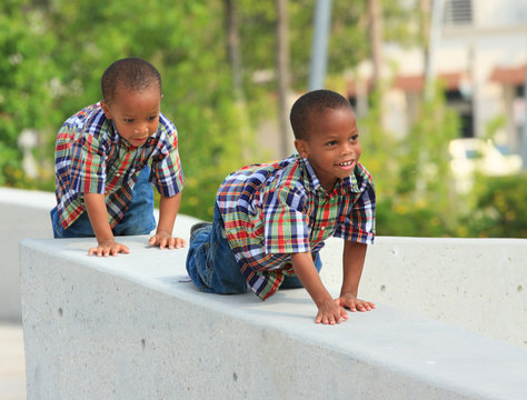 Kids crawling on a ledge