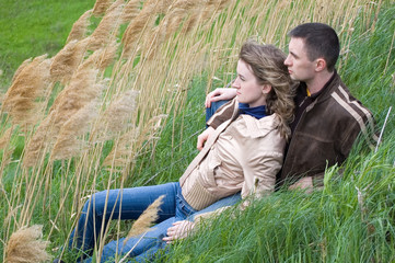 Wall Mural - guy and girl sits in canes and look forward