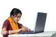 indian girl and laptop computer isolated on white