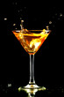 alcohol splash in martini glass on black background