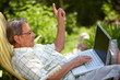 Healthy senior man in his elderly 70s using laptop computer