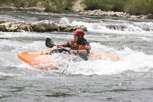 Whitewater Kayaker Surfing A Wave On Grade 3 Rapid