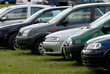 Cars parked on the green grass